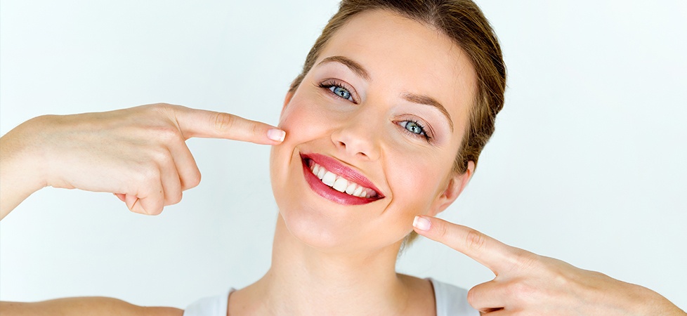 woman pointing to perfect smile