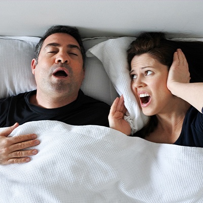woman mad at husband yawning