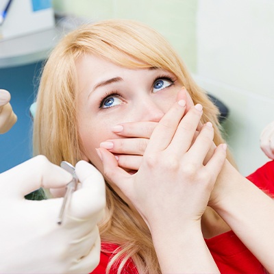 woman covering smile