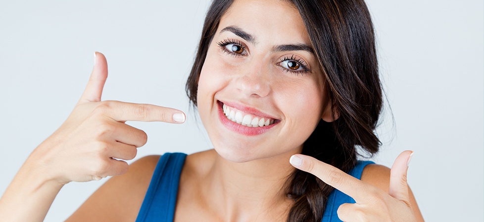 woman pointing to smile