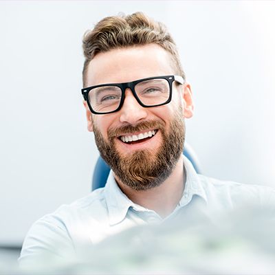 man with glasses smiling