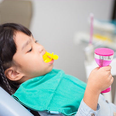 toddler getting fluoride treatment