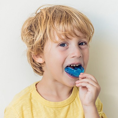 boy putting in mouthguard