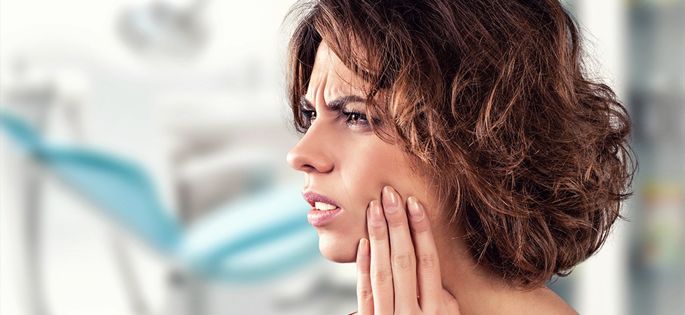 woman with curly hair in pain