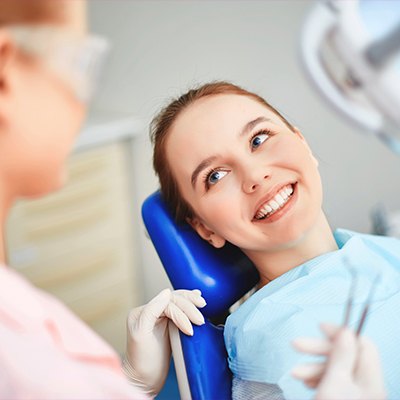 teen girl smiling at dentist