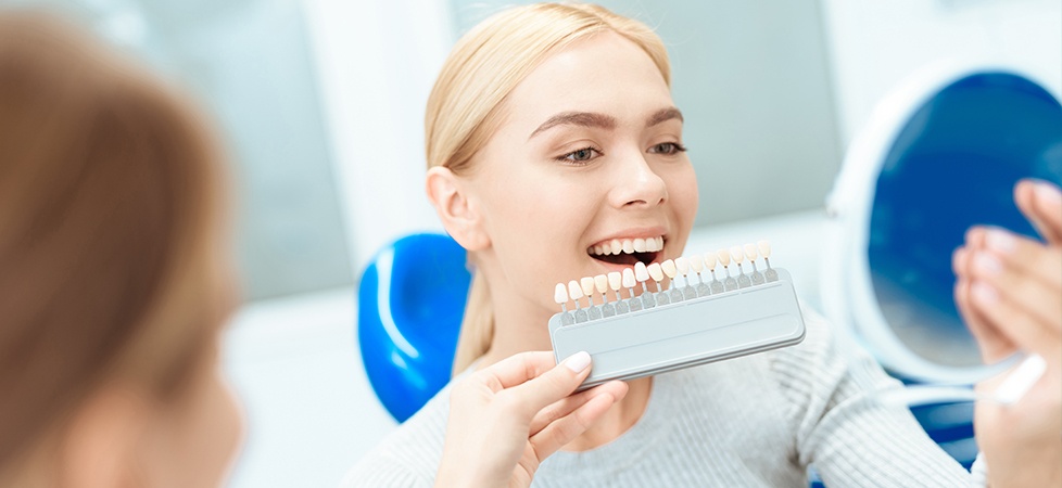 woman checking veneer in mirror