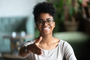 person holding their hand out and smiling