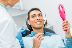 man smiling after visiting his dentist in Haverhill