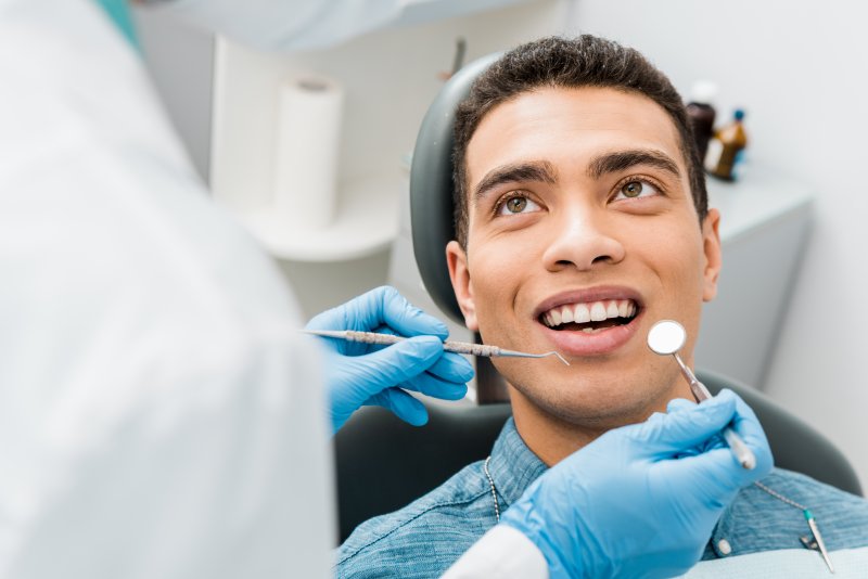 man smiling at cosmetic dentist in Bradford
