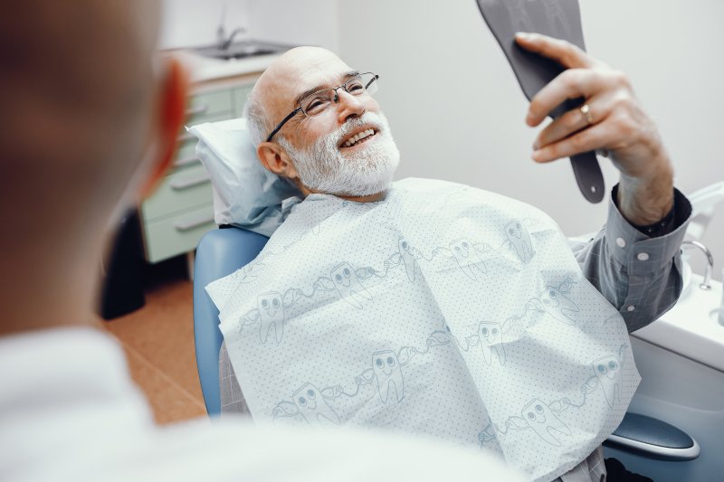 Man smiling with a dental crown