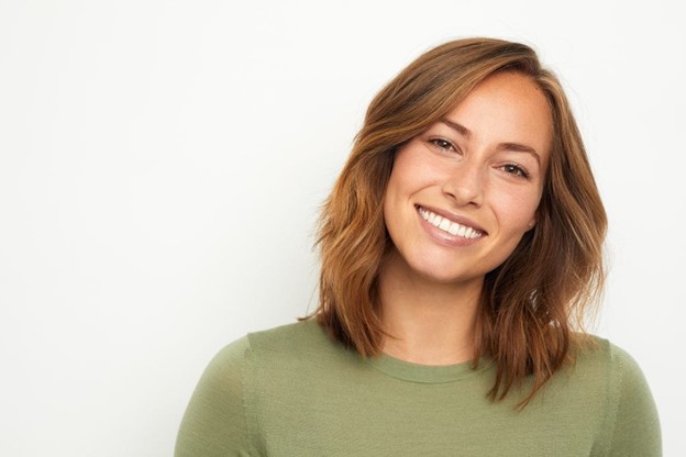 person smiling after receiving dental implants